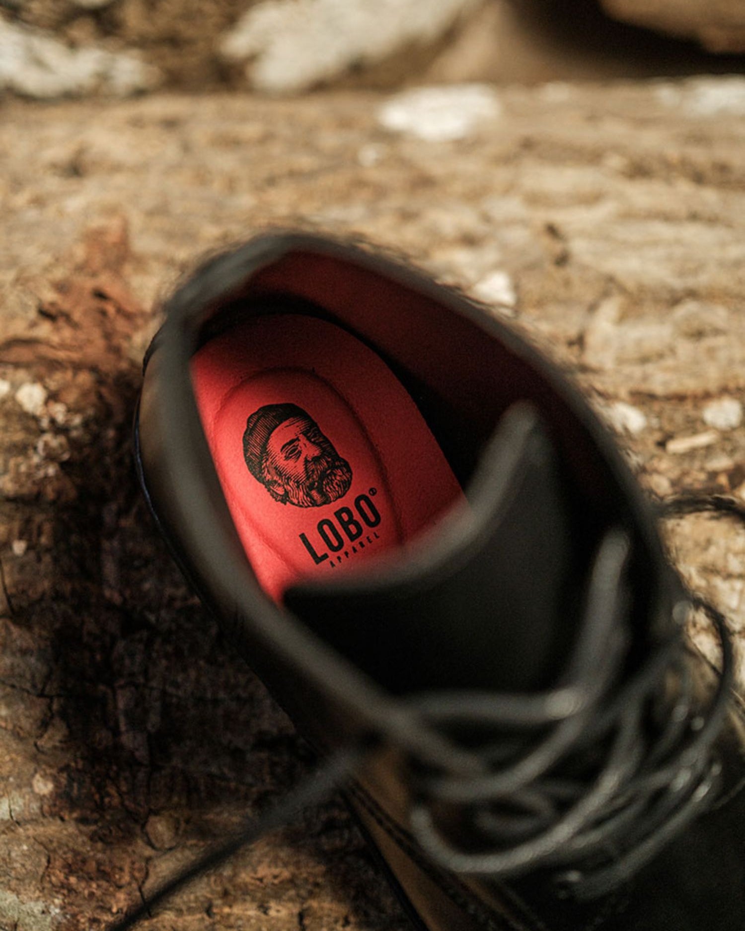 Lobo All Black Boots interior with red leather insole and branded logo, highlighting comfort and quality.