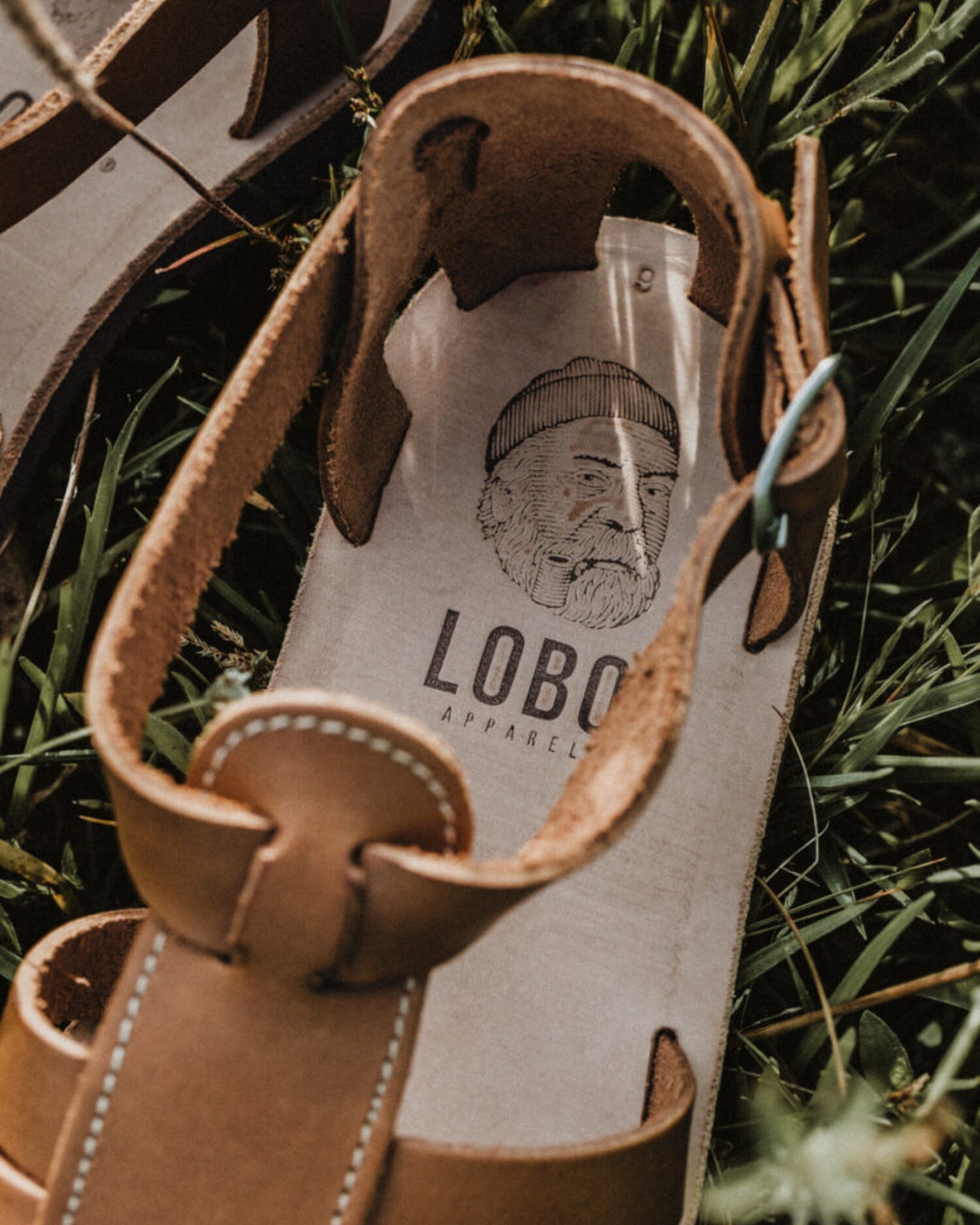 Close-up of the Lobo sandals' leather insole, highlighting the Lobo Apparel logo