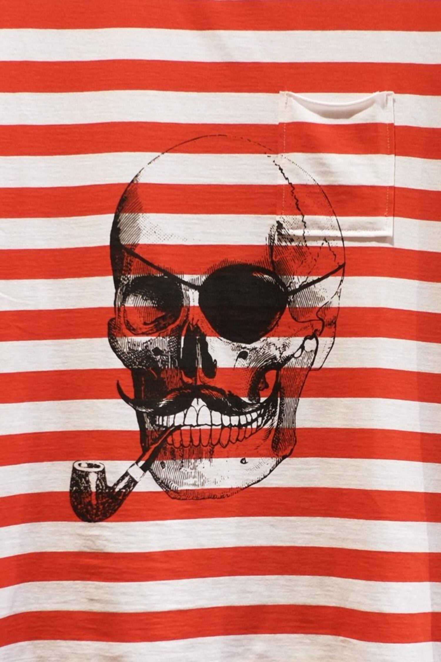 Close-up of the pirate skull graphic and small chest pocket on the LOBO tank shirt, highlighting the high-quality cotton fabric texture.