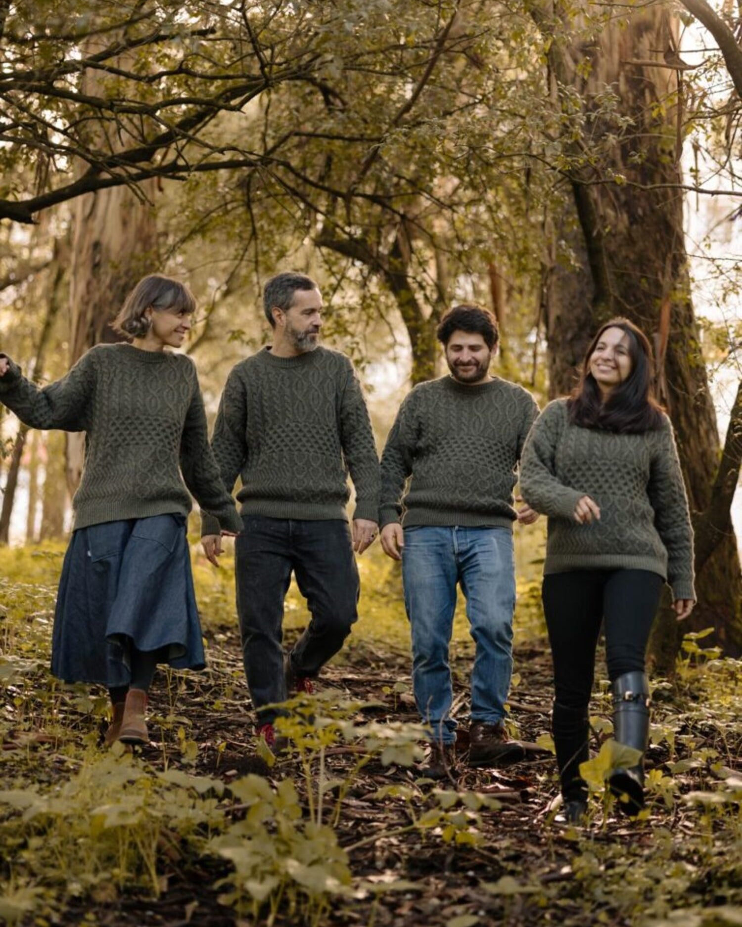 Group of four people walking through a forest, wearing the Verde Grisalho sweater from the Lobo Apparel x Do Zero sustainable collaboration.