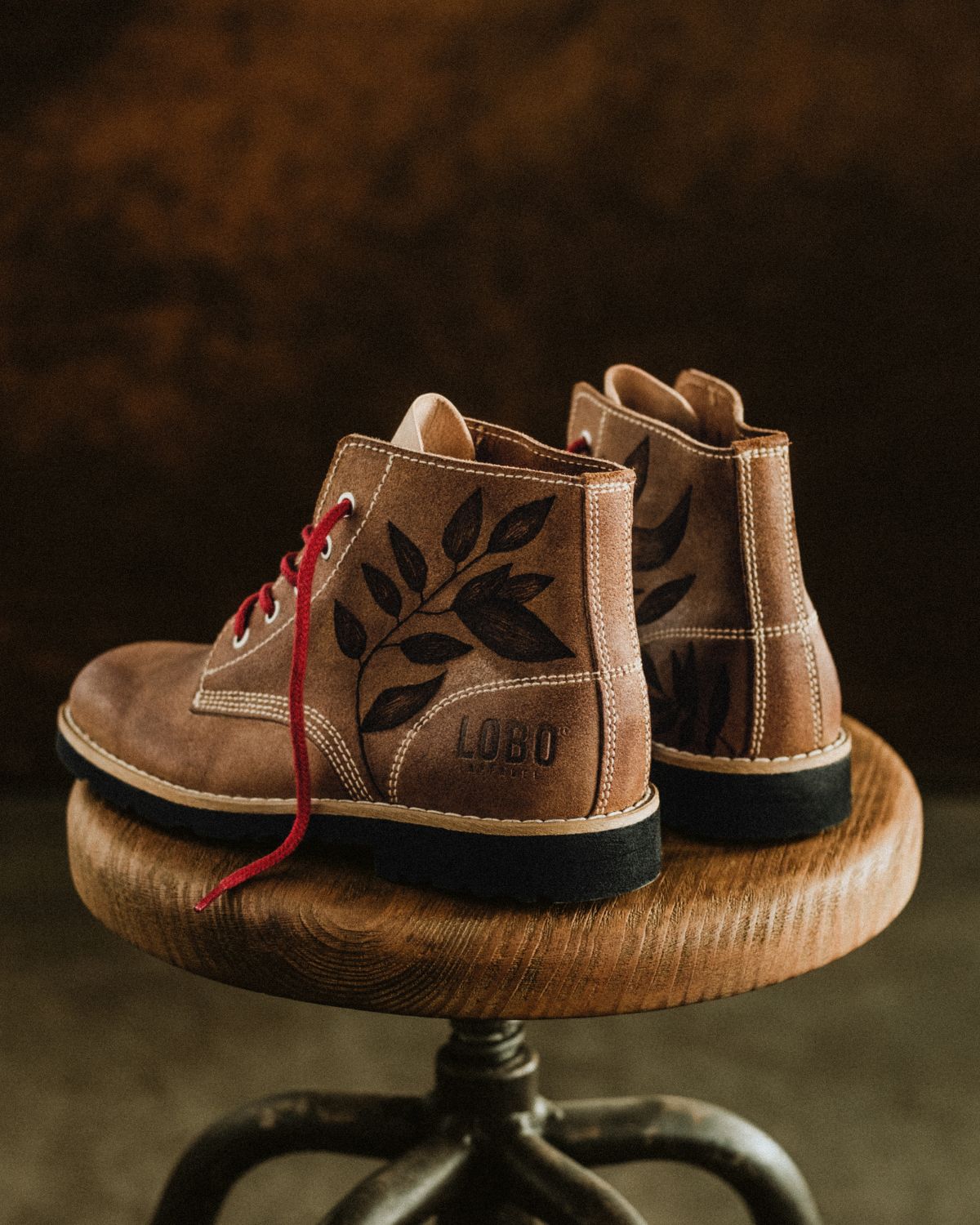 Rear and side perspective of the Lobo Raw Boots by Cláudia Salgueiro, highlighting the continuity of the hand-drawn designs and the artisanal sole finish.