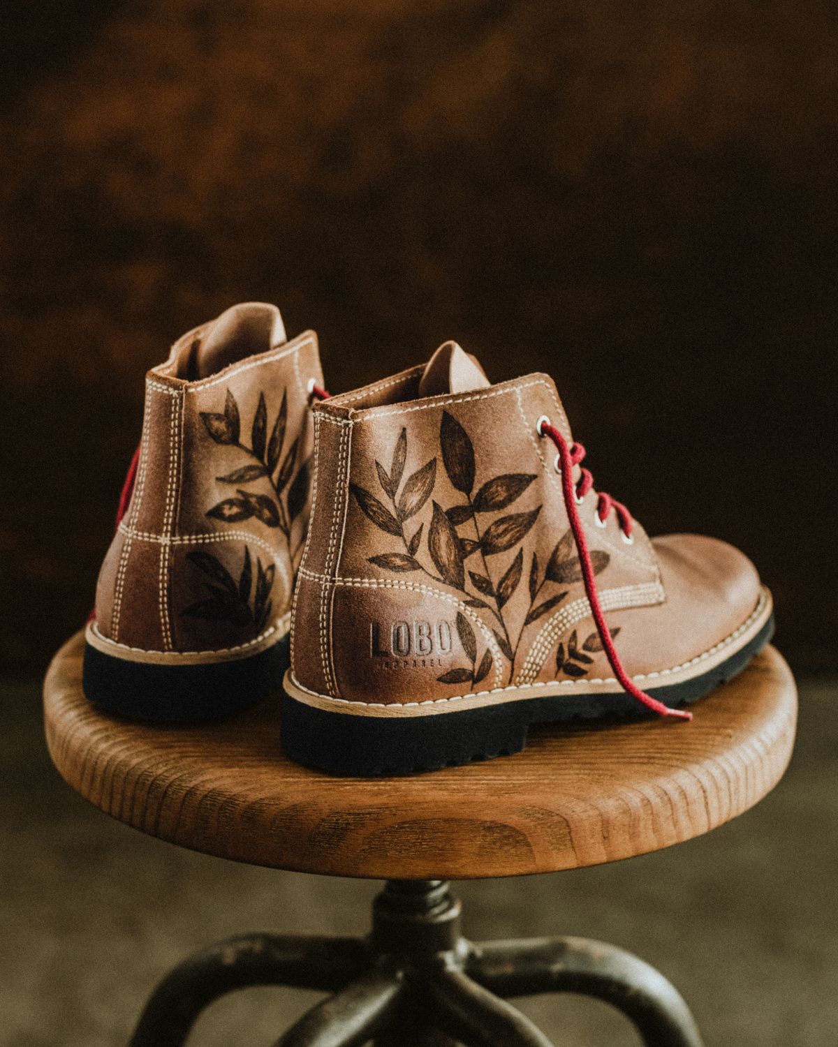 Artistic perspective of the Lobo Raw Boots by Cláudia Salgueiro, highlighting the unique design and the LOBO logo embossed on the heel. High-quality Portuguese footwear with an artisanal finish.