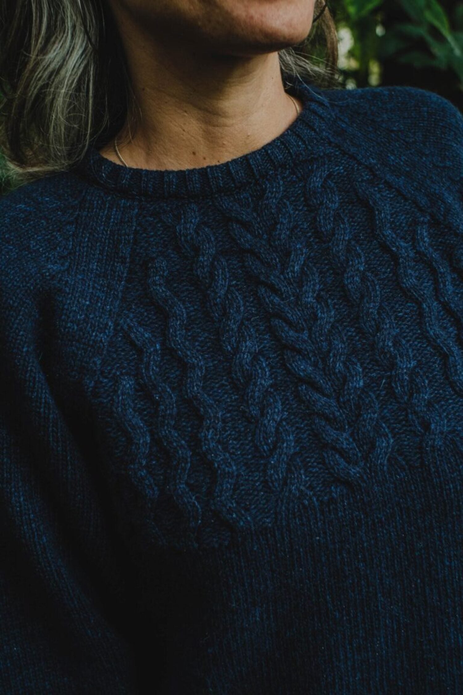 Close-up of the front panel of the Lobo Blue Fisherman sweater, showing the premium braided knit detail.