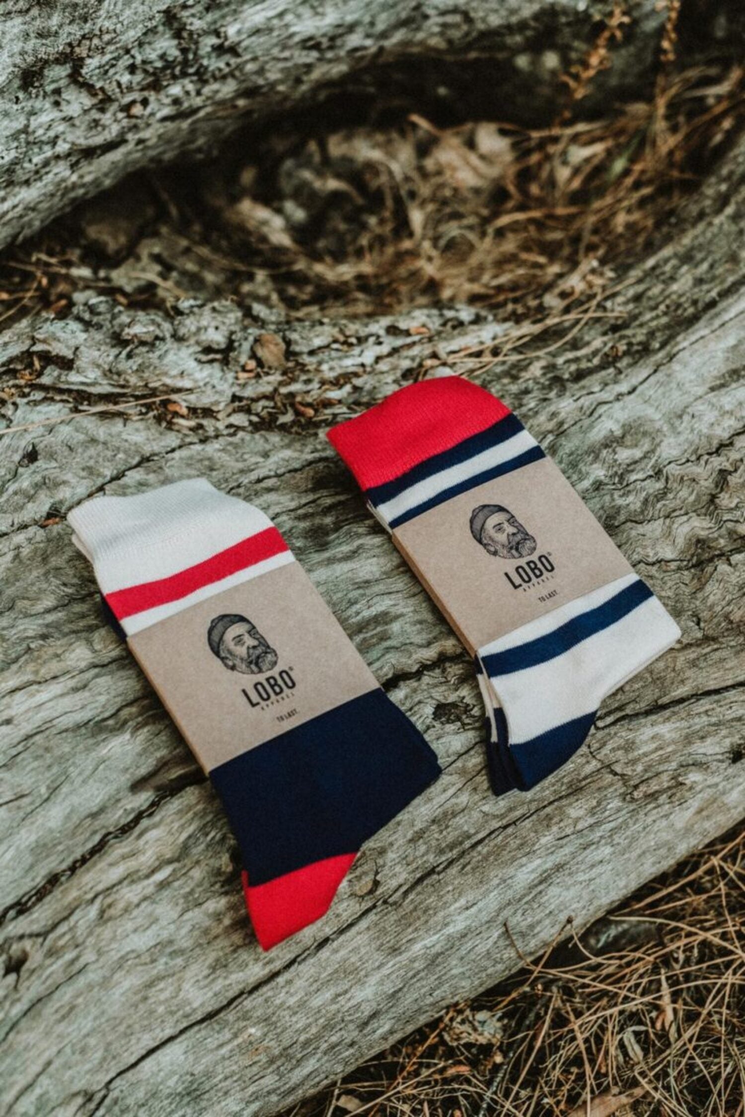 Two Lobo Blue Socks with Kraft paper bands and brand logo, designed to be paired with boots or sandals.