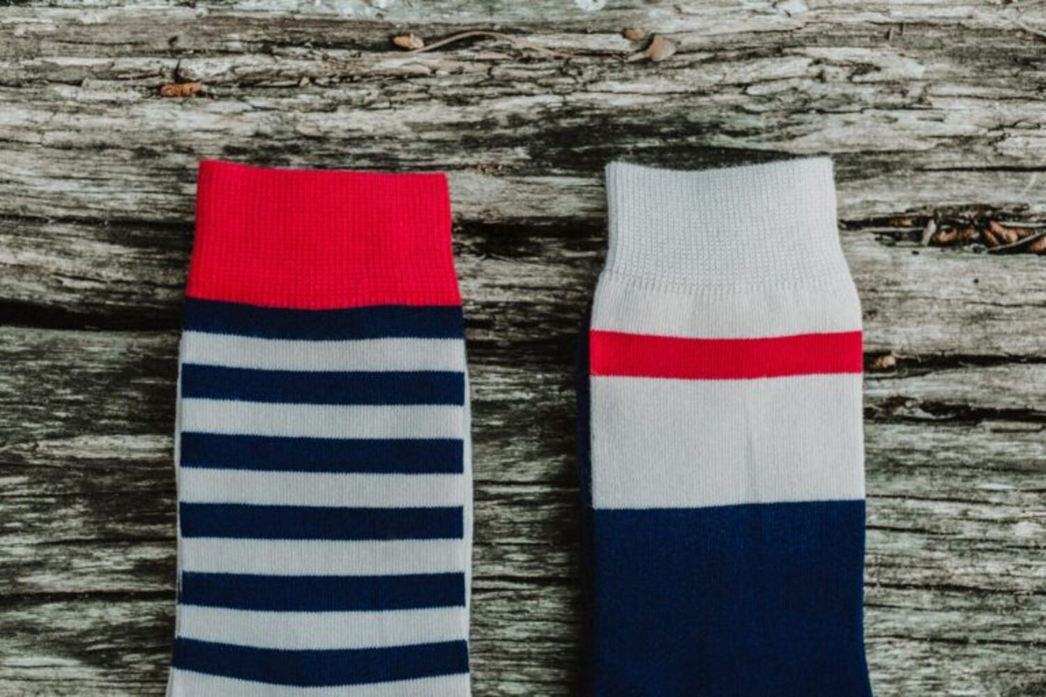 Comparison of Lobo sock patterns: one with blue and white horizontal stripes and another with a color-block design and red stripe.