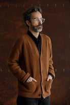 Man wearing the Lobo Apparel brown wool cardigan over a black shirt, classic and timeless heritage style.