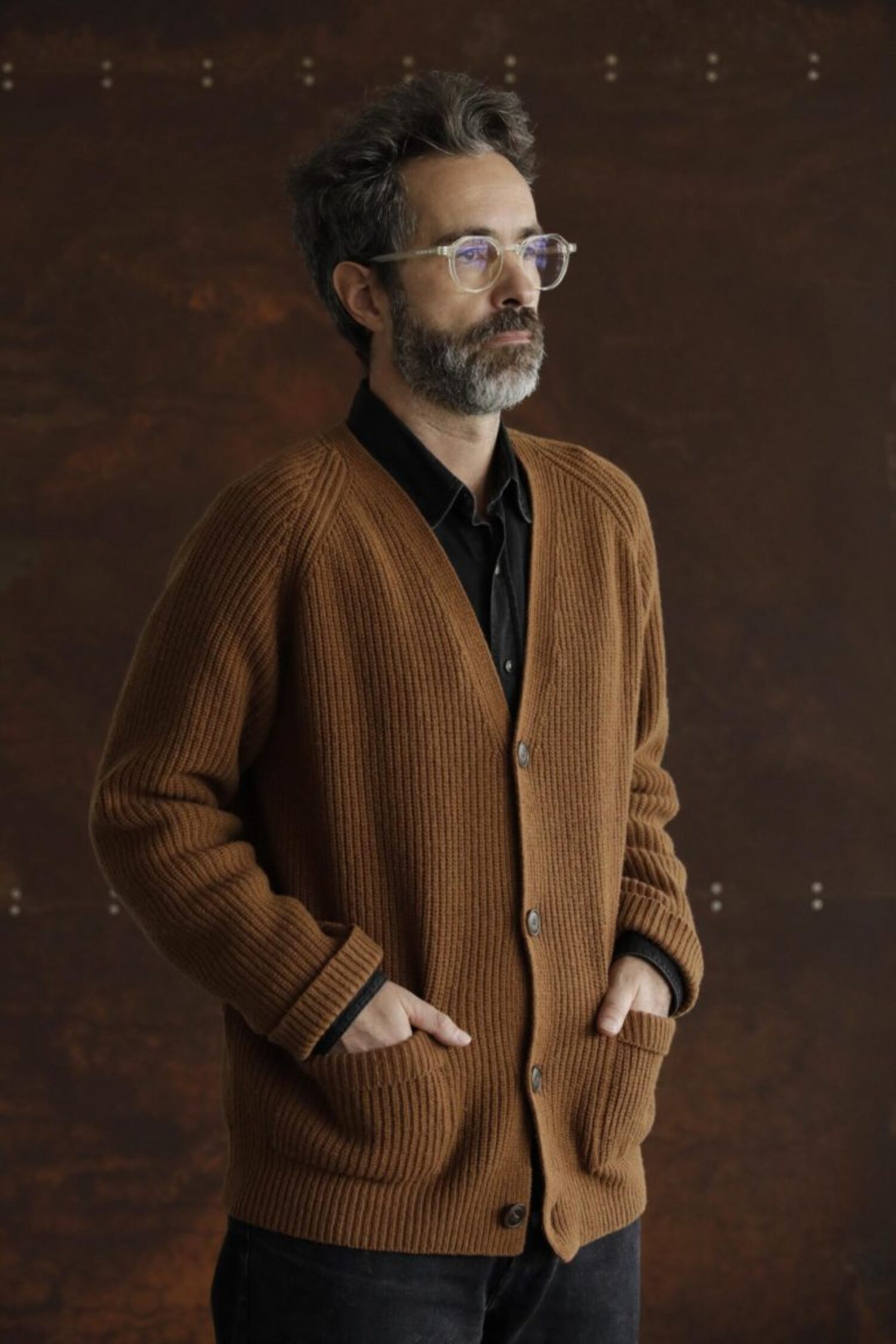 Man wearing the Lobo Apparel brown wool cardigan over a black shirt, classic and timeless heritage style.