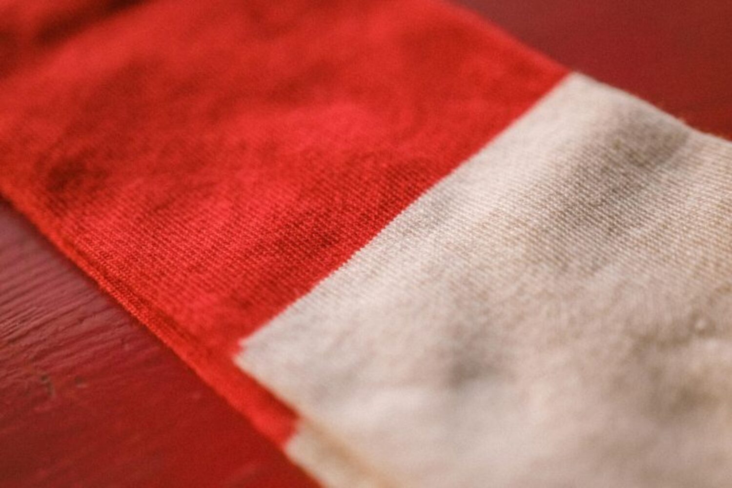 Macro shot of the premium natural fibers texture of the Lobo Classic Red Socks, showcasing the softness and high-quality fabric finish.