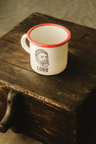High-angle top view of the LOBO Red Rim mug on rustic wood, showing the white interior and ergonomic handle.