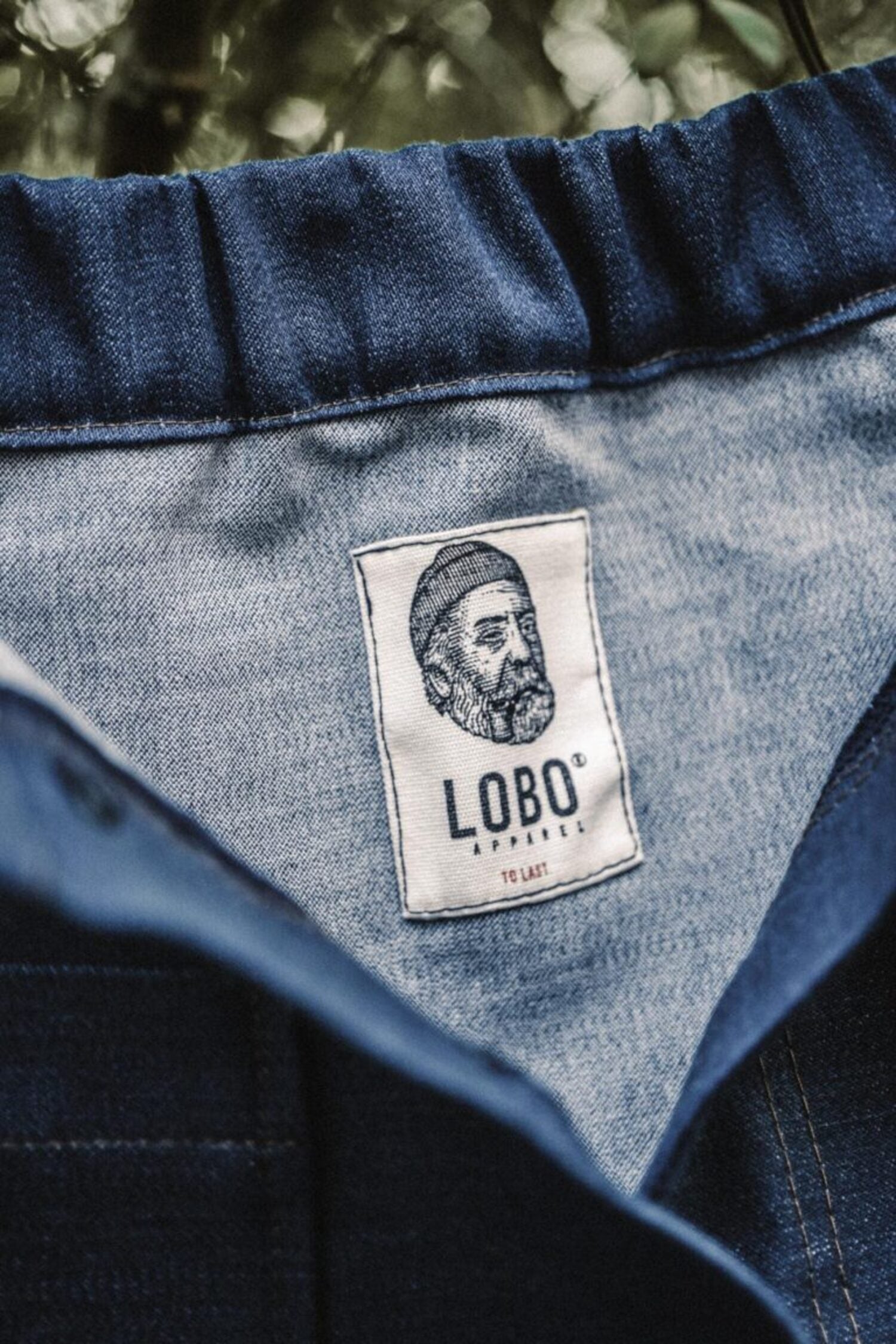Close-up of the Lobo Apparel woven label on a handmade denim skirt made from leftover fabric.