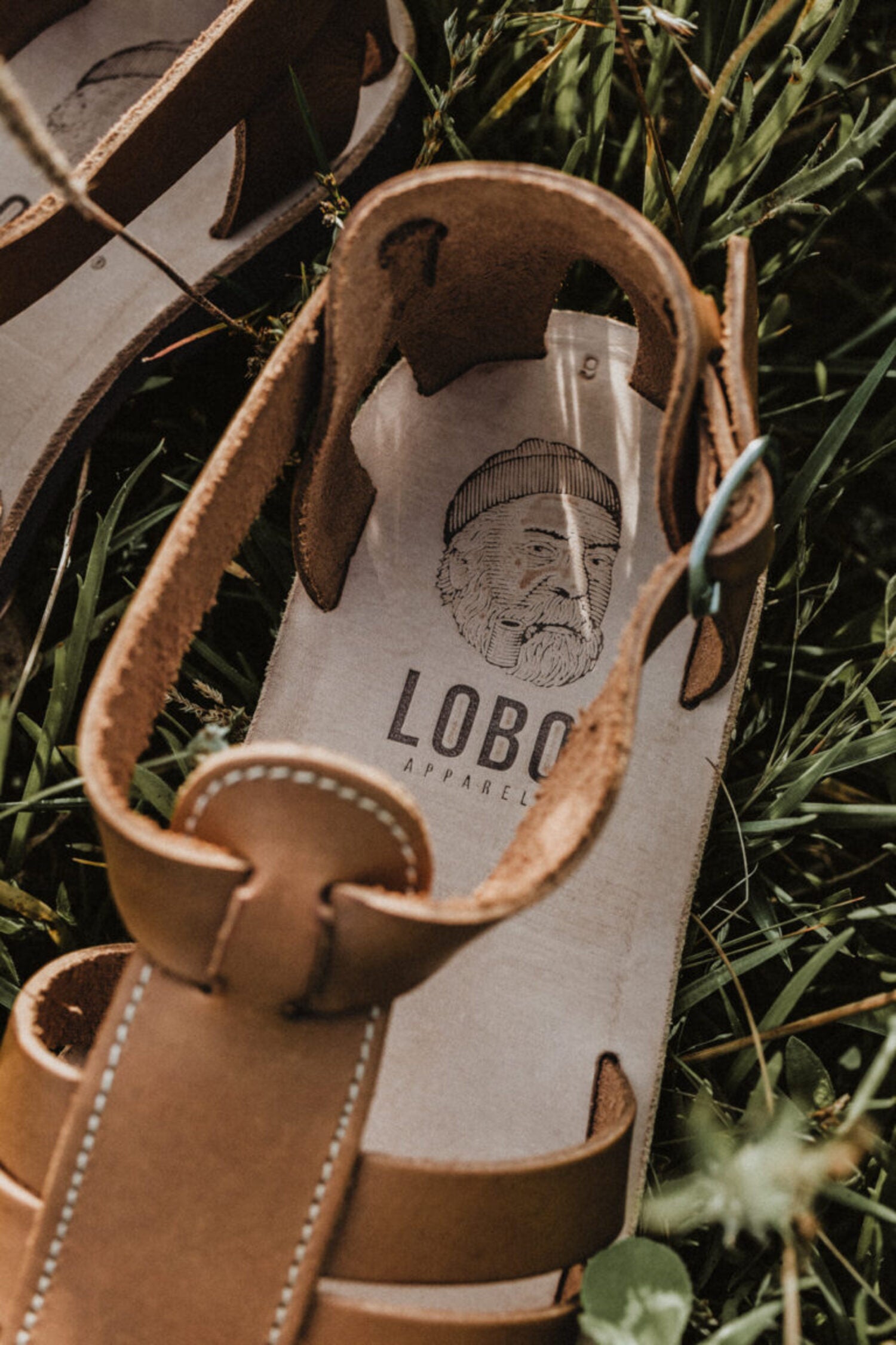 Close-up of the Lobo sandals' leather insole, highlighting the Lobo Apparel logo