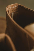 Close-up of zigzag stitching on the heel of Lobo Raw brown leather boots, showing durable construction.