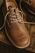Front close-up of Lobo Raw leather shoe with cream cotton laces and reinforced stitching.