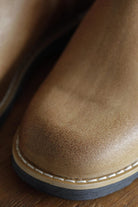 Macro shot of textured tan leather toe cap and welt stitching on Lobo Raw boots.