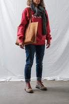 Female model wearing Lobo Warm Boots, denim jeans, red sweatshirt, and a grey wool scarf.
