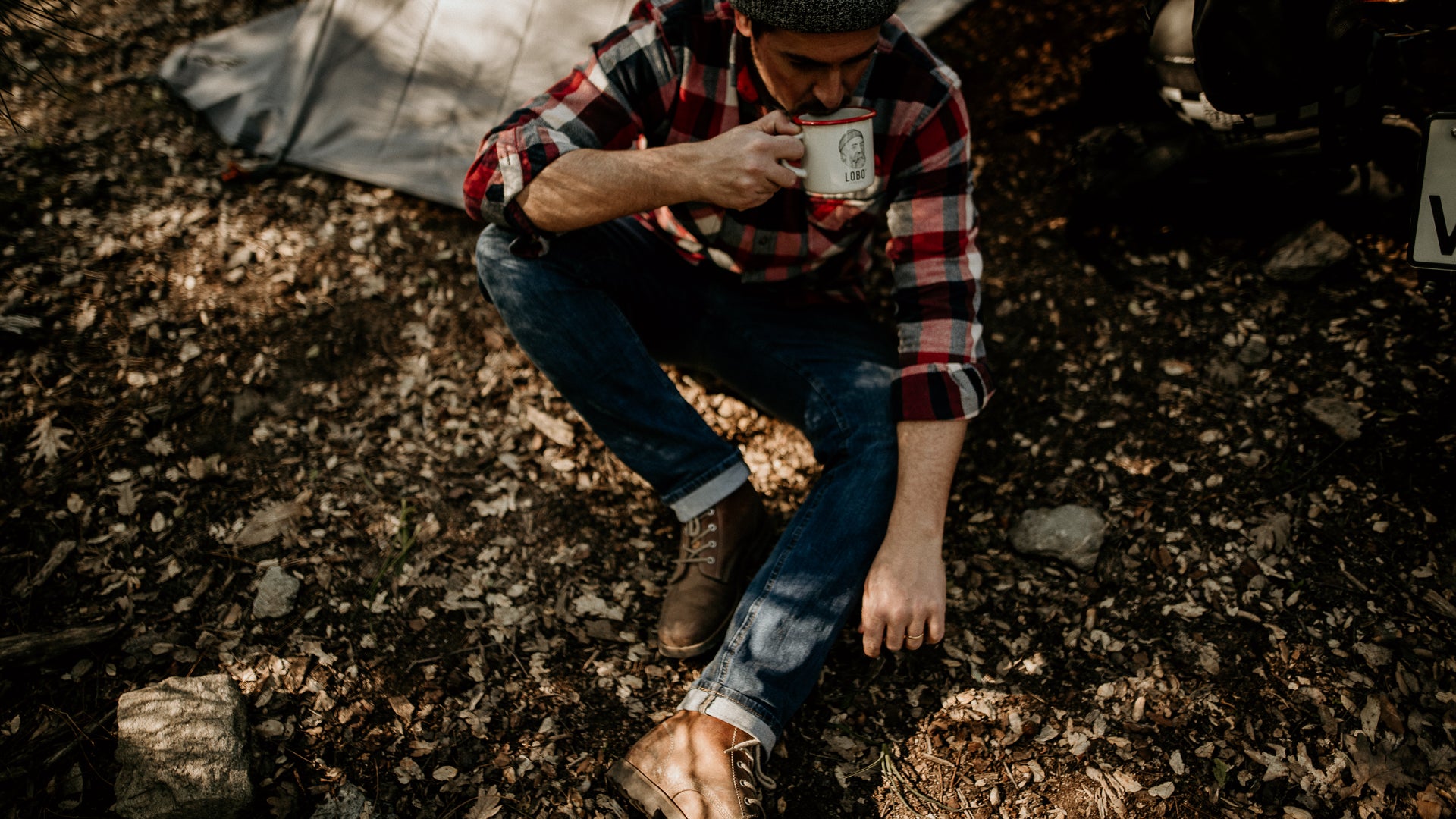 Inspirational outdoor lifestyle quote: "A warm coffee in hand, boots on feet, and nature all around. Small moments of calm and connection.
