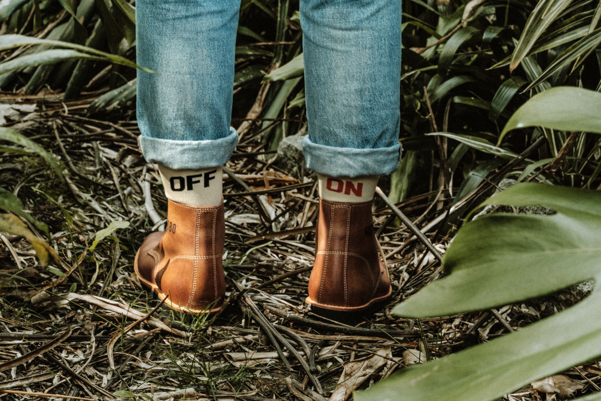 Man wearing Lobo x Naked Malt leather boots and jeans on a nature trail.