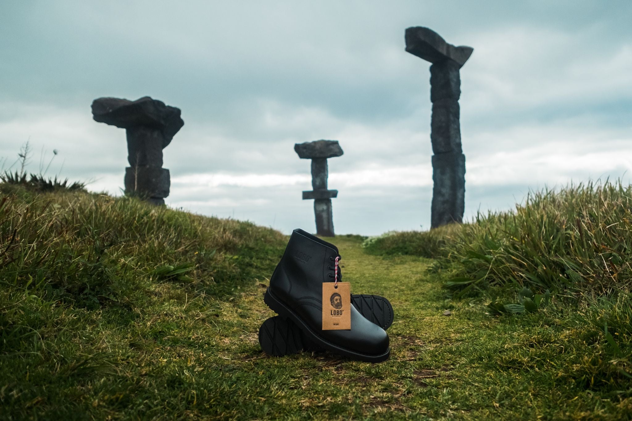 Lobo Apparel All Black Boots set in a mystical landscape with standing stone formations, shot by Paulo Jorge in the Azores.