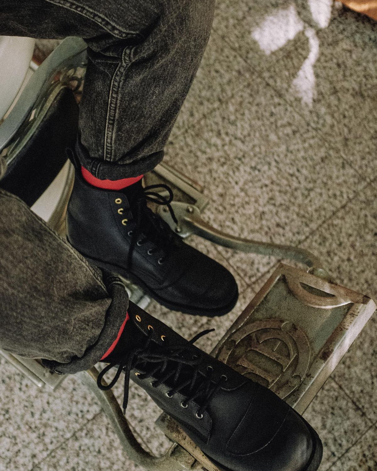 Close-up of Lobo Tigre Boots featuring golden eyelets and Lobo Classic Red Socks, showcasing the protective shifter toe reinforcement.