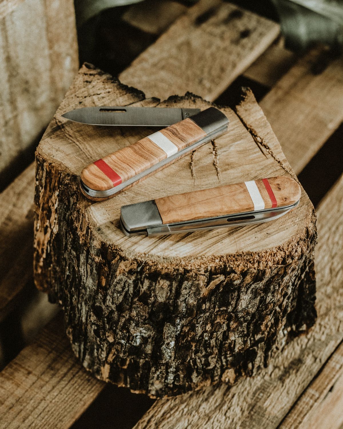 Set of two LOBO pocket knives by Fernando Mendes, showing one open blade and one closed, highlighting the natural wood handles and unique handcrafted design.